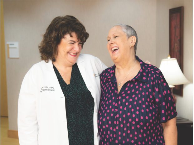 nurse and female patient laughing together