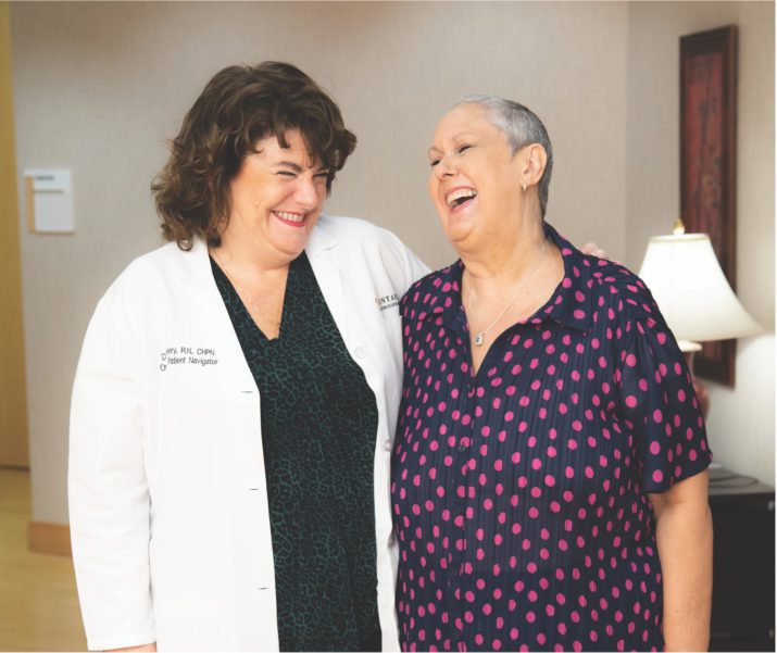 nurse and female patient laughing together