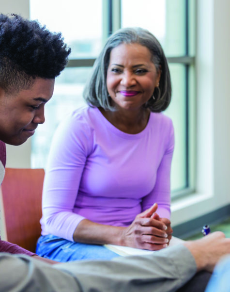 doctor talking to teen and mother