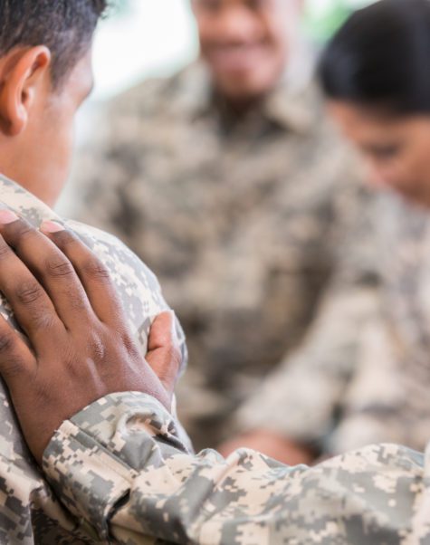 group of soldiers comforting each other