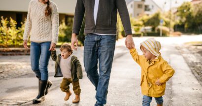 mom and dad walking with two young kids