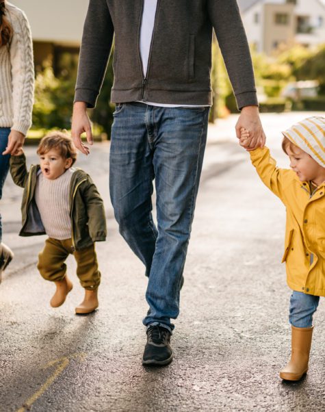 mom and dad walking with two young kids