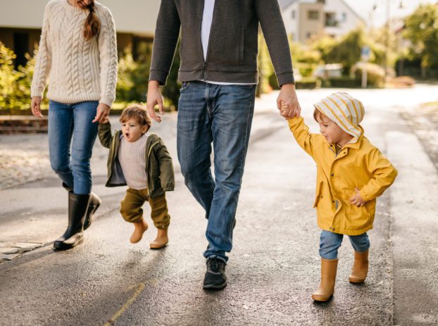 mom and dad walking with two young kids