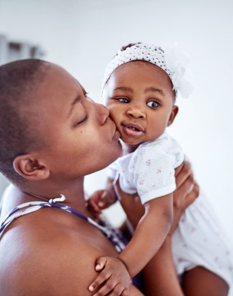 mother kissing baby