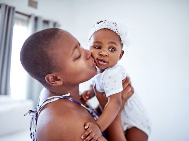 mother kissing baby