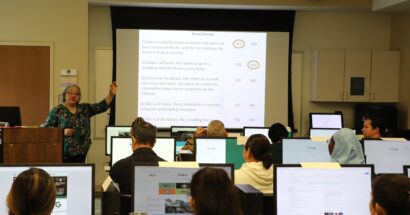 Adult learners in class with computers
