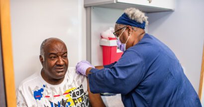 Sentara community care worker administering vaccine